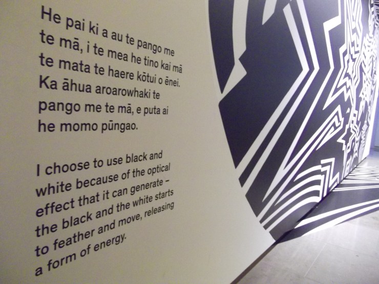 English and Mauri text beside graphic wall art at Auckland Art Gallery