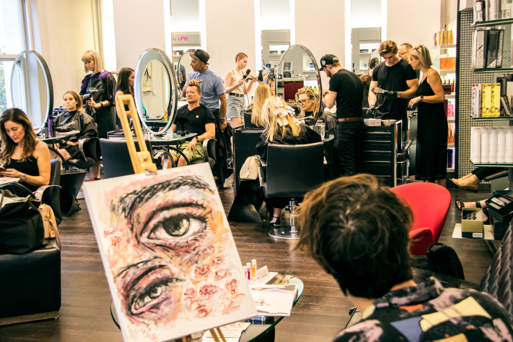 Artist Brendan Hartnett at Rakis on Collins painting event in salon